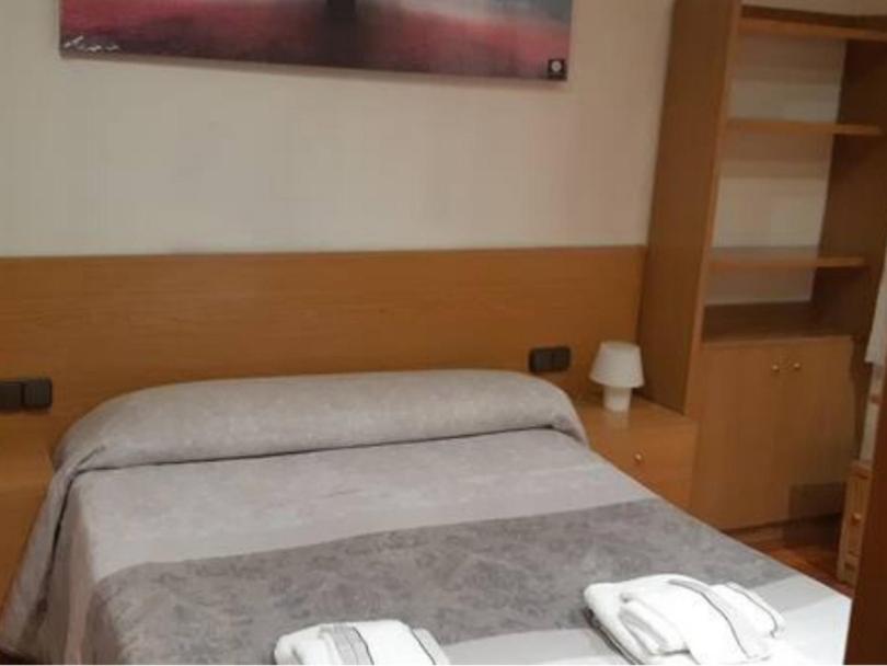 sypialnia z łóżkiem i telewizorem na ścianie w obiekcie Precioso!! apartamento en el centro de Sabadell w mieście Sabadell