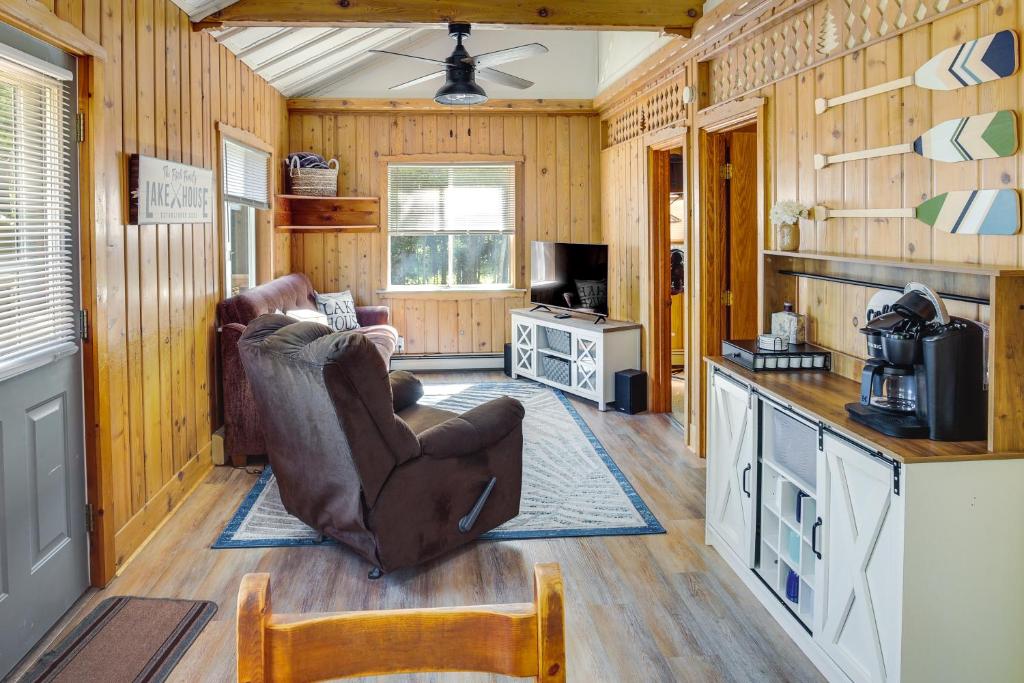 a living room with a chair and a kitchen at Lakefront Marenisco Cabin with Private Dock! in Bergland