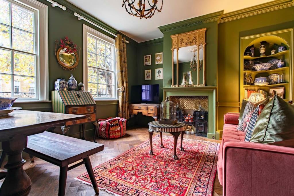 a living room with green walls and a red couch at Next to Bath Abbey & Roman Baths - Gorgeous Georgian House in Bath