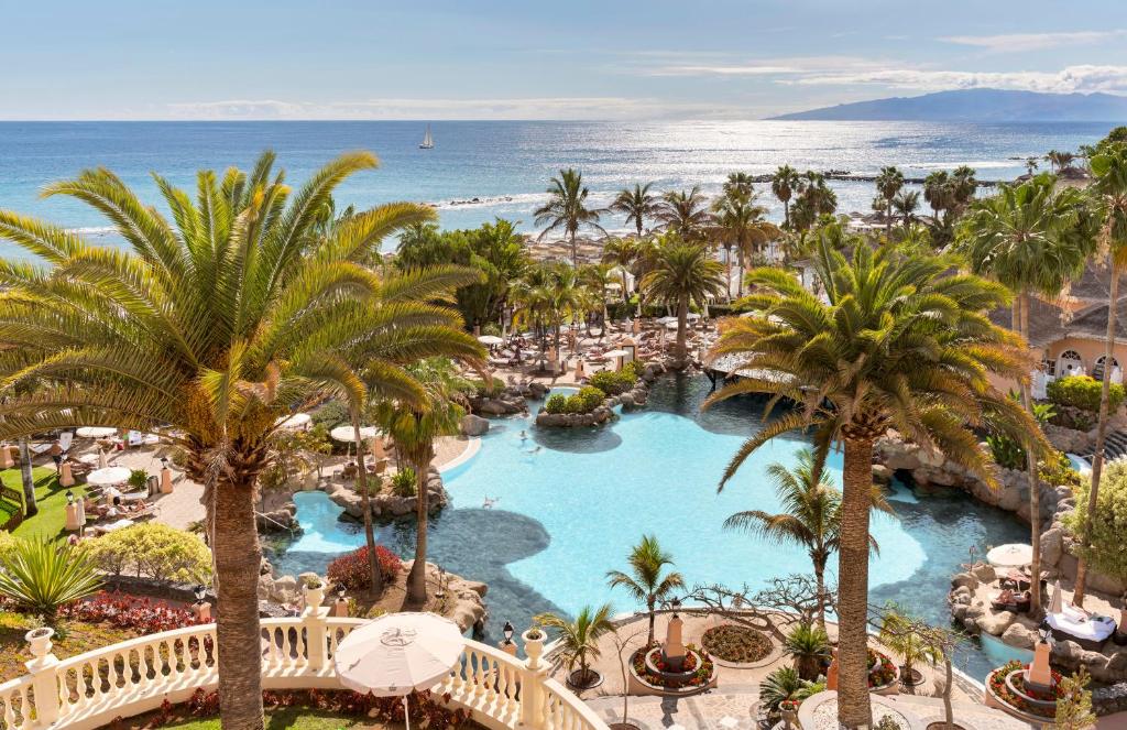 an aerial view of a resort with a pool and the ocean at Bahia del Duque in Adeje