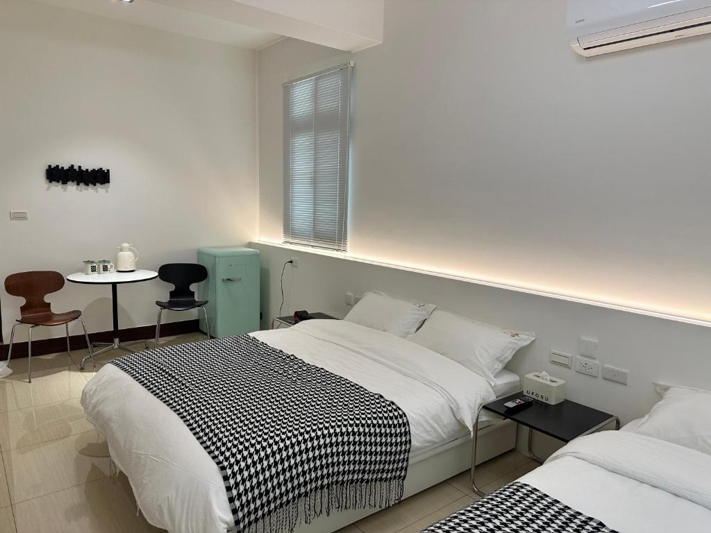 Katil atau katil-katil dalam bilik di Qiestop B&B