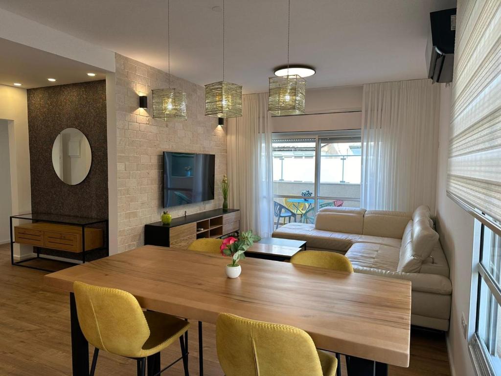 a living room with a table and a couch at luxury 2 BD by dizingof near the beach in Tel Aviv