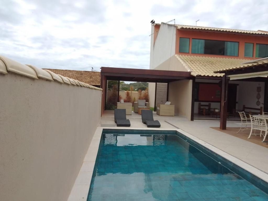 a swimming pool in the backyard of a house at Casa Duas Torres in Búzios