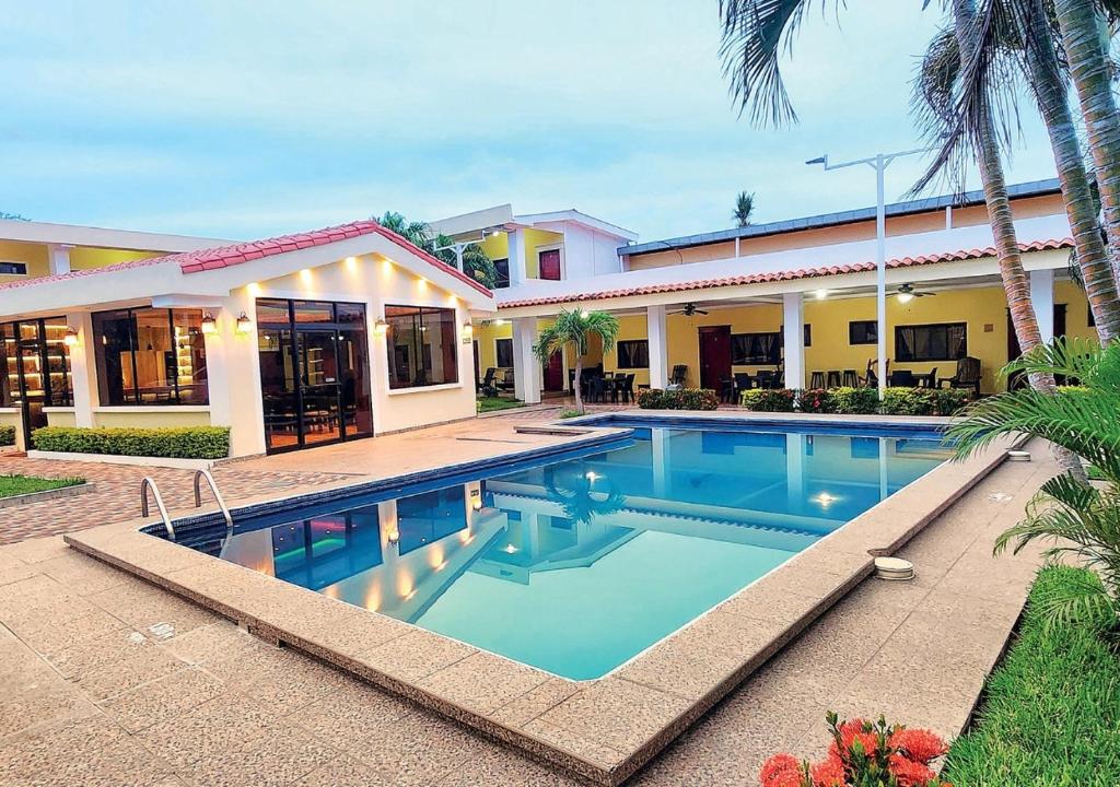 a swimming pool in front of a house at Hotel y Restaurante Maria Ofelia in San Luis