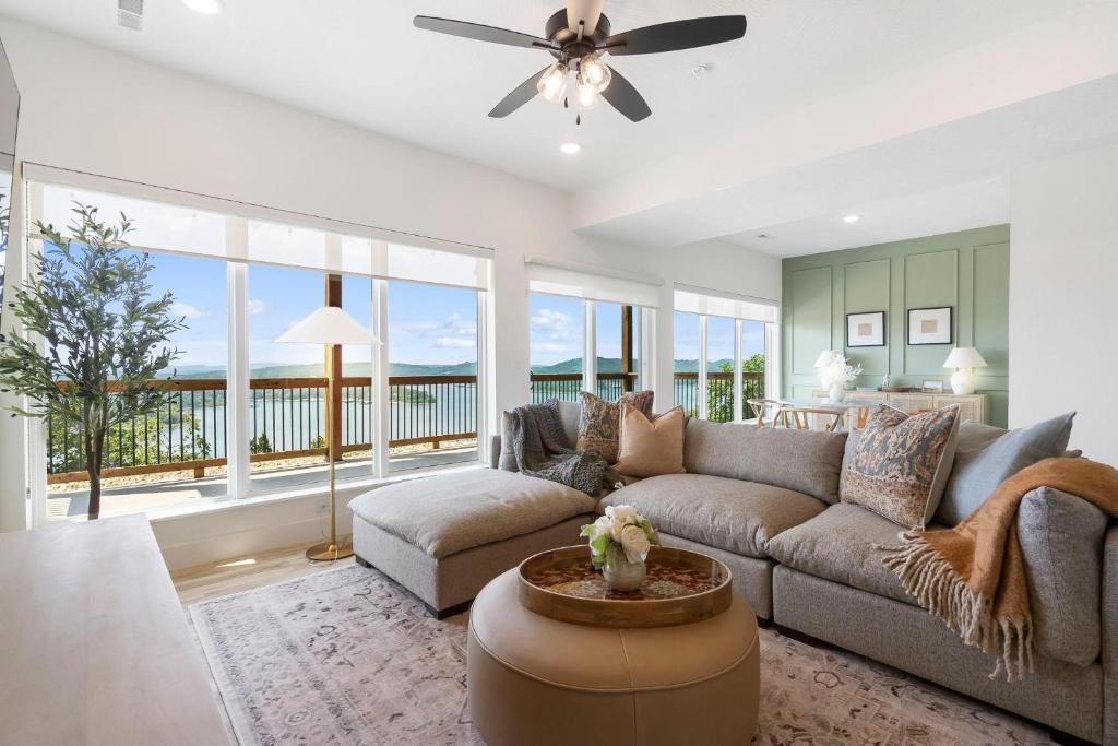 a living room with a couch and a ceiling fan at Panoramic Lake Views, Free Silver Dollar City Tickets, Stunning Decor in Kimberling City
