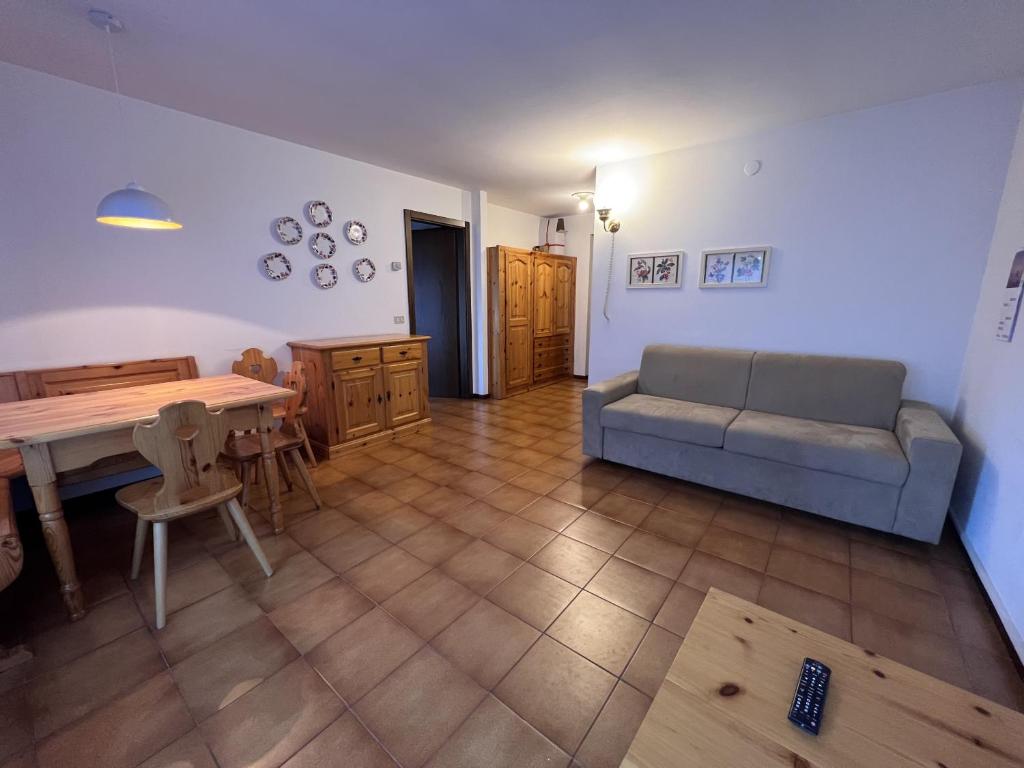 ピンツォーロにあるAppartamenti Residenza Alpinaのリビングルーム(ソファ、テーブル付)
