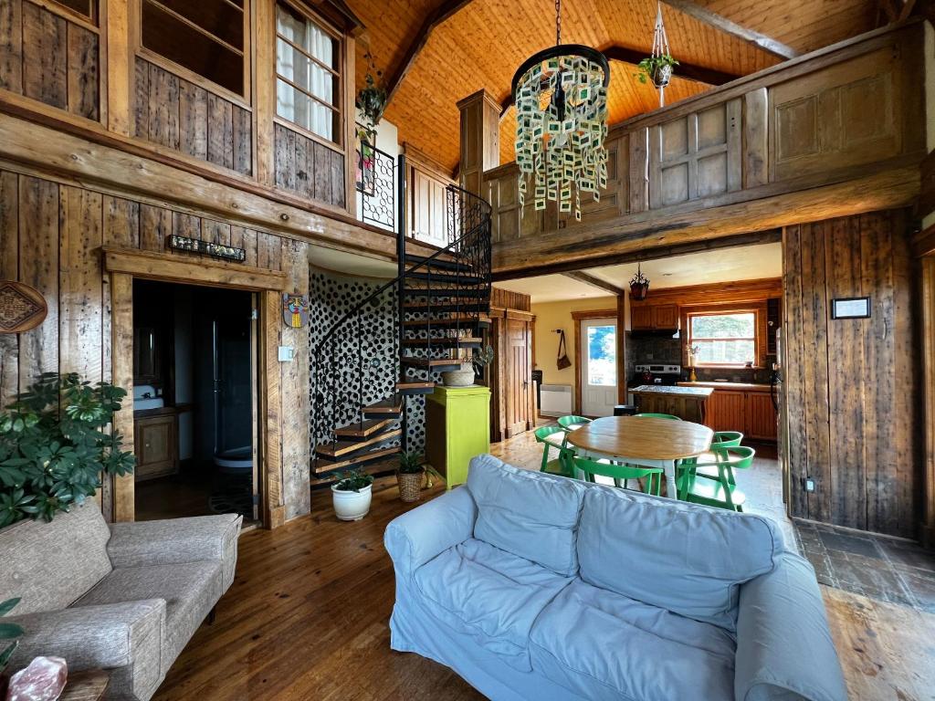 a living room with a couch and a table at Chalet Epicea in Sainte-Anne-des-Monts