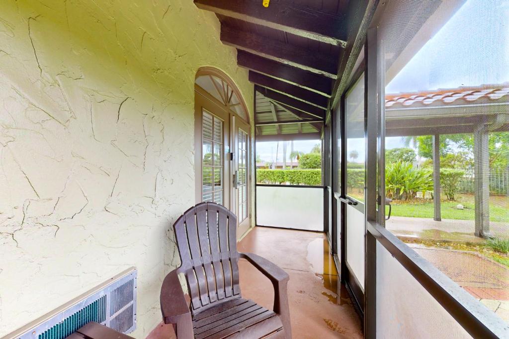 a chair sits on the porch of a house at Port of the Islands A101 in Naples