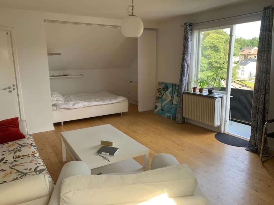 a living room with a couch and a table at Good cheap apartment in a central location in Borås