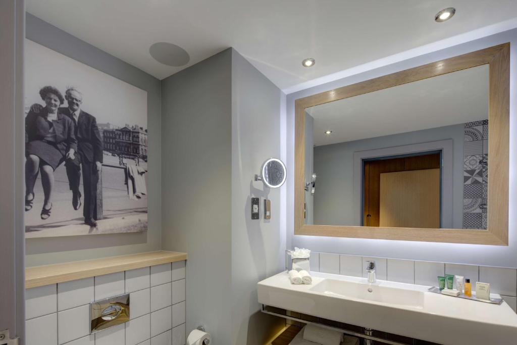 a bathroom with a sink and a mirror at Hilton Bournemouth in Bournemouth