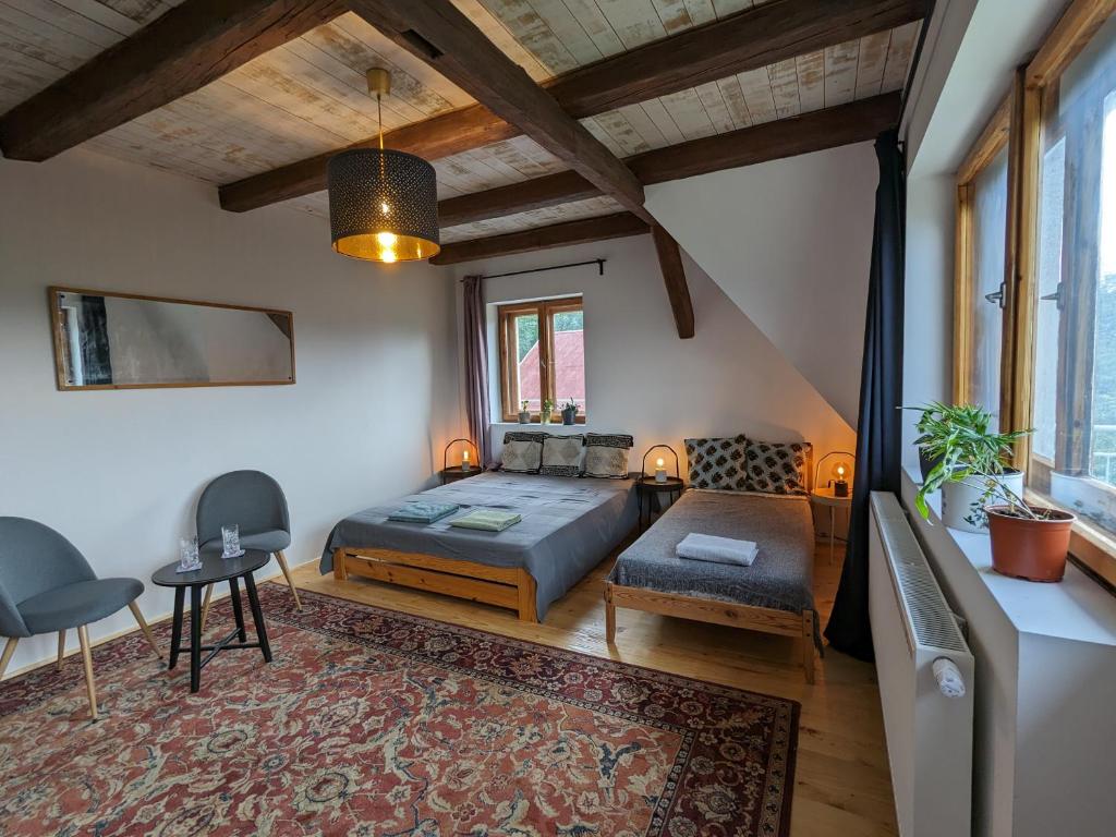 a bedroom with a bed and a couch and a table at Pod Lubogoszczem in Mszana Dolna