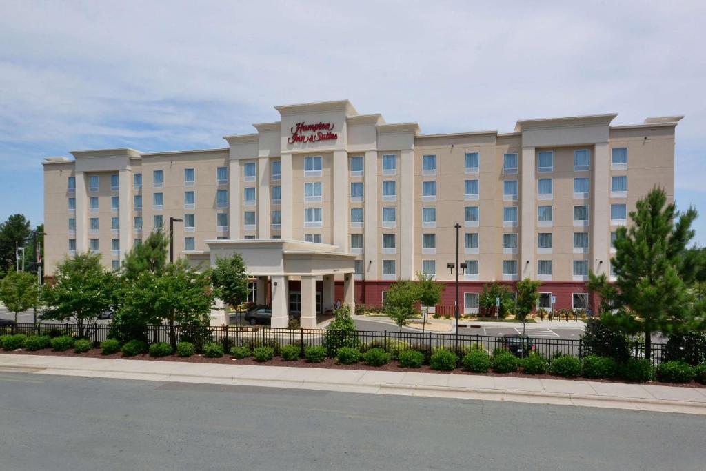a hotel building with a fence in front of it at Hampton Inn & Suites Durham North I-85 in Durham