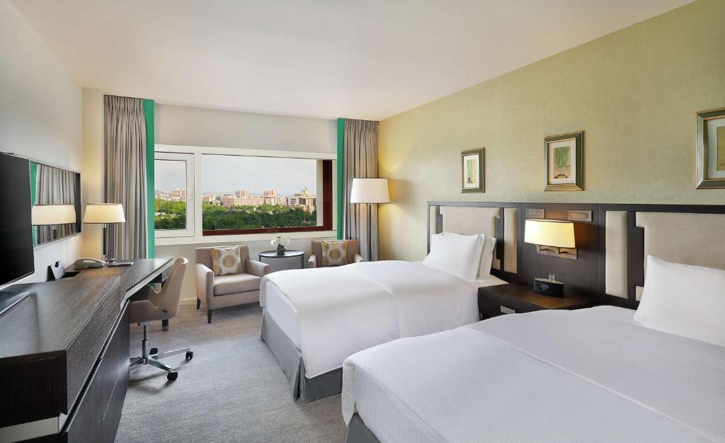 Ένα ή περισσότερα κρεβάτια σε δωμάτιο στο Transcorp Hilton Abuja