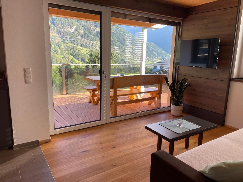 a living room with a large sliding glass door at Apart Finazzer in Wenns