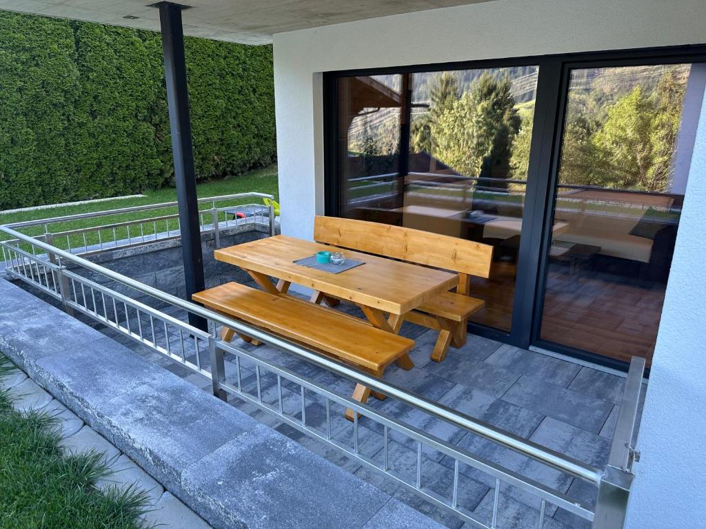 a wooden bench sitting on the side of a house at Apart Finazzer in Wenns