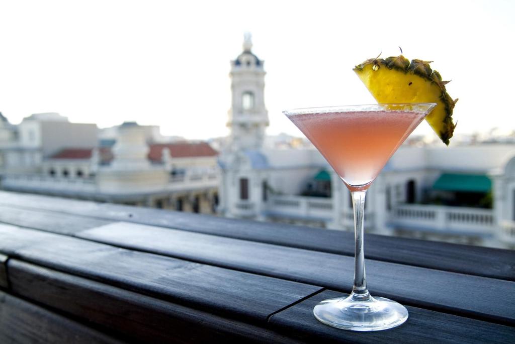 a drink sitting on top of a wooden table at Sweet Hotel Continental in Valencia