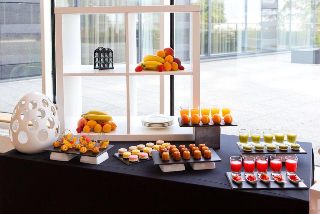 a display of fruits and juices on a table at Hilton Paris Charles De Gaulle Airport in Roissy-en-France