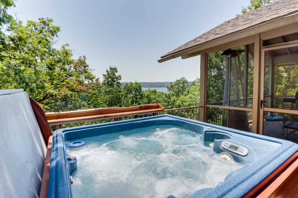 a hot tub on the deck of a house at Hot Tub and Deck Margaritaville Resort Retreat! in Osage Beach