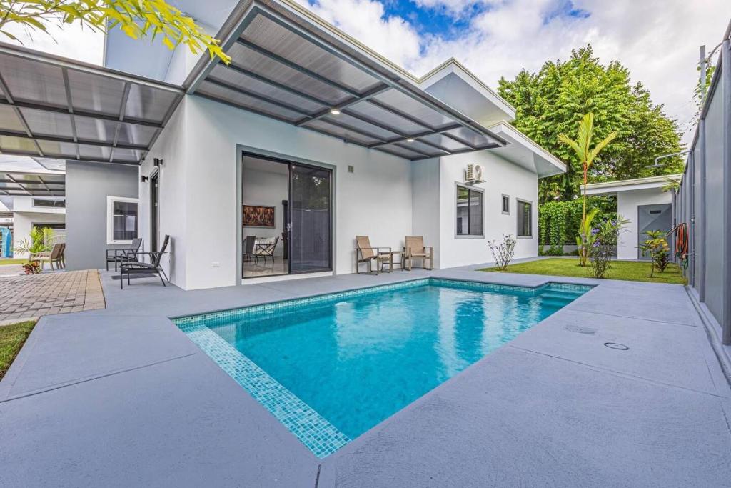 a swimming pool in the backyard of a house at Casamar Villa's in Uvita
