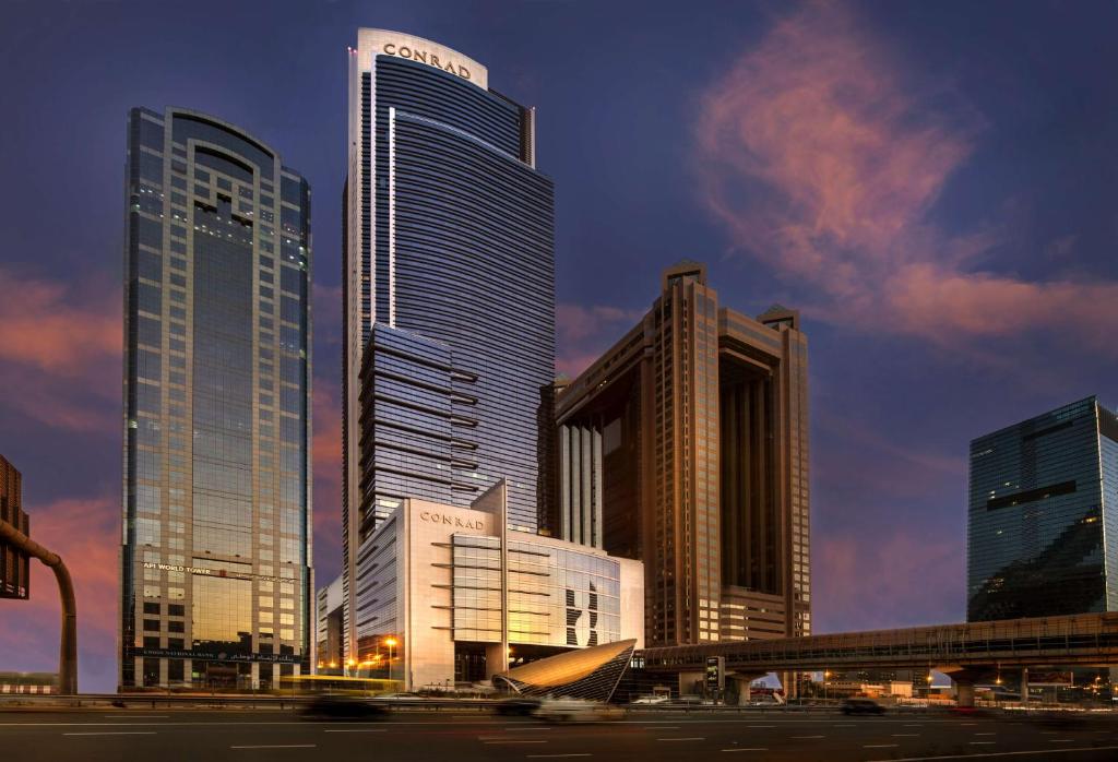 a city skyline with tall skyscrapers in a city at Conrad Dubai in Dubai