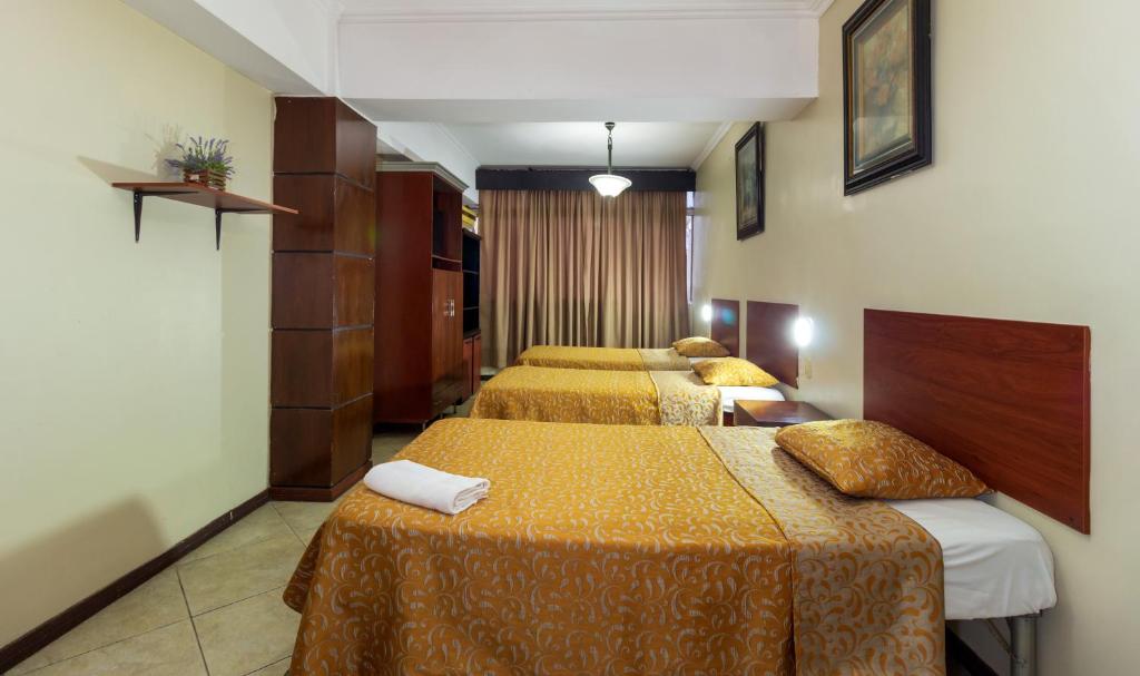 Postel nebo postele na pokoji v ubytování Hotel Malecon Inn