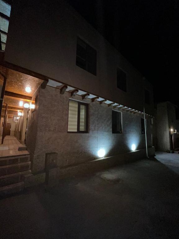 a building with lights on the side of it at night at мртапрапвак in Bukhara