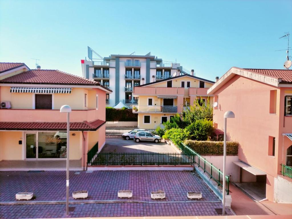 a parking lot with buildings in the background at Appartamento Solaris 200 m dal mare in San Salvo