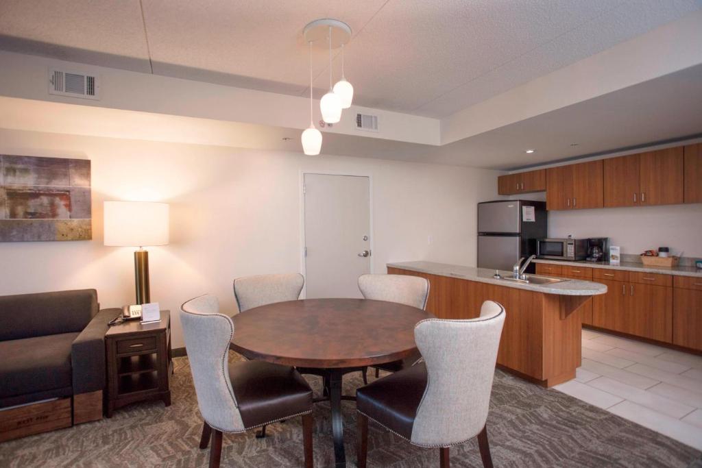 a kitchen and dining room with a table and chairs at SpringHill Suites by Marriott Athens West in Athens