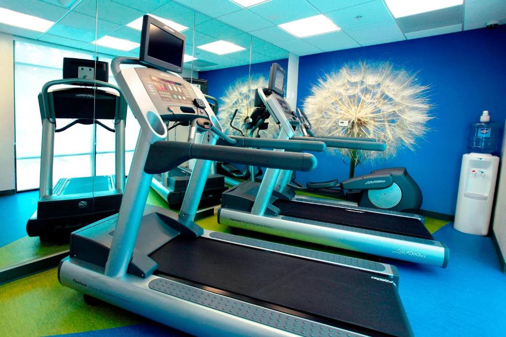 a gym with a treadmill in a blue room at SpringHill Suites by Marriott Athens West in Athens