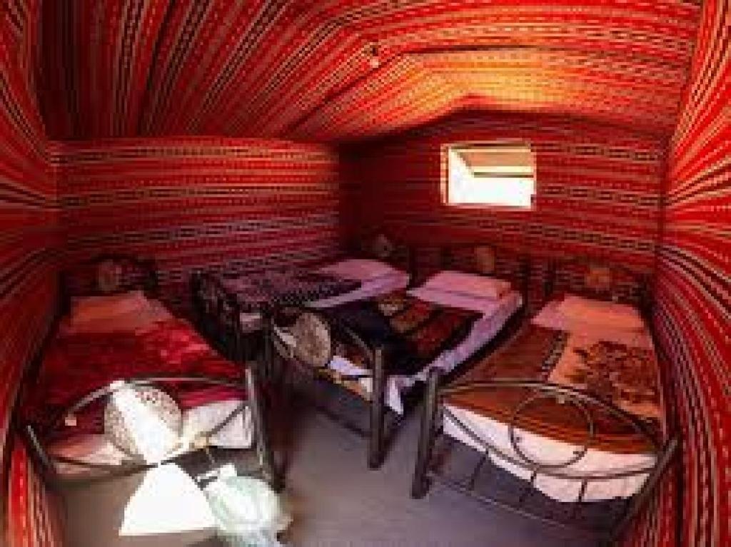 a room with a bunch of beds in it at Wadirum winter in Wadi Rum