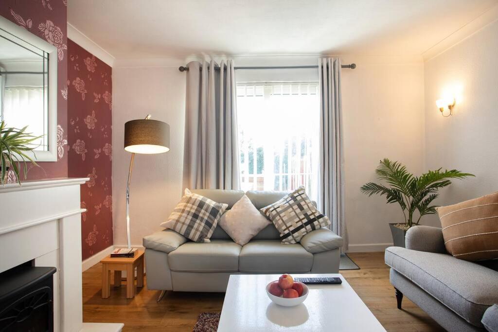 a living room with a couch and a table at Rawmarsh House, Rotherham for contractors & Families, off-road parking, high speed wifi in Rotherham