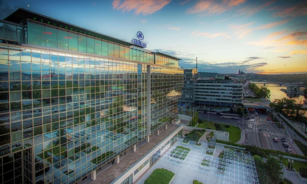 an office building with a sunset in the background at Hilton Prague Hotel in Prague