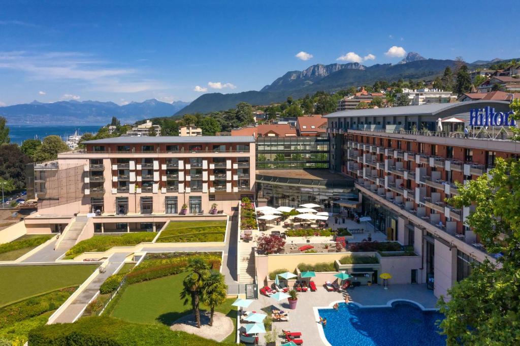 an aerial view of a hotel with a resort at Hilton Evian Les Bains in Évian-les-Bains