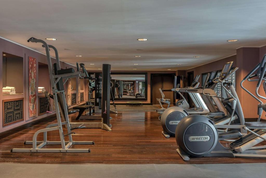 a gym with several treadmills and elliptical machines at Hilton Evian Les Bains in Évian-les-Bains