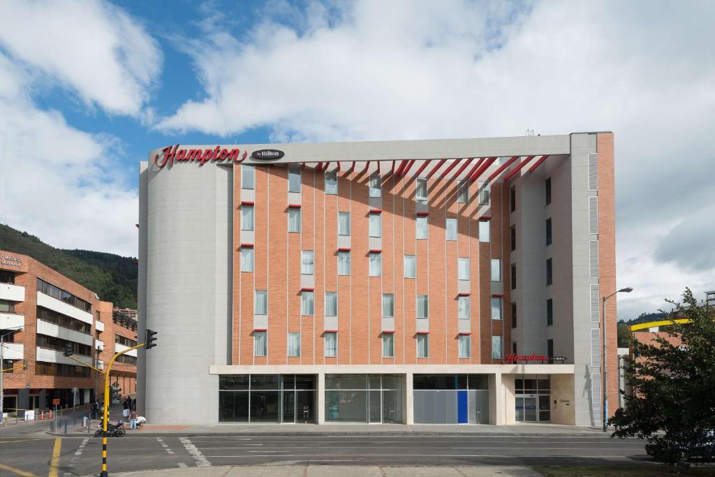 a building with a sign on the side of it at Hampton by Hilton Bogota Usaquen in Bogotá