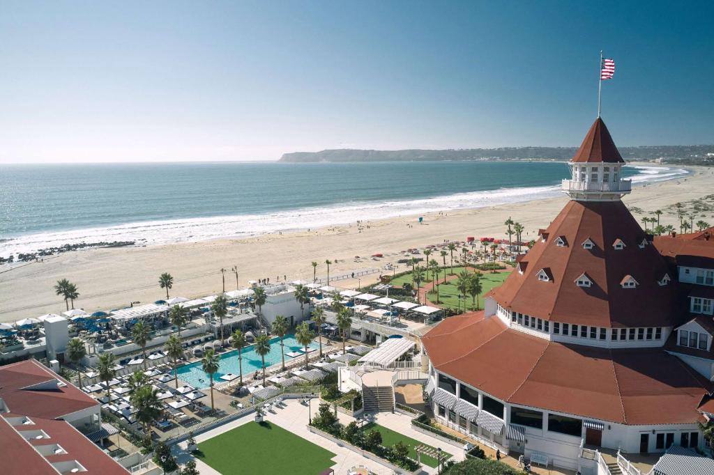 an aerial view of a resort and the beach at Hotel del Coronado, Curio Collection by Hilton in San Diego