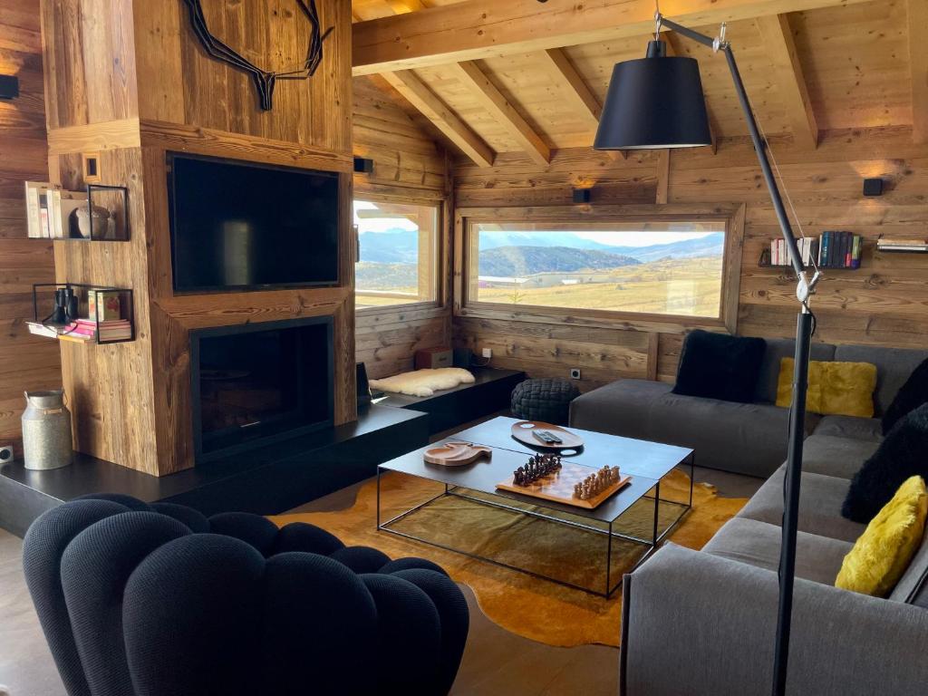 a living room with a couch and a fireplace at Chalet Standing Exceptionnel in Bolquere Pyrenees 2000