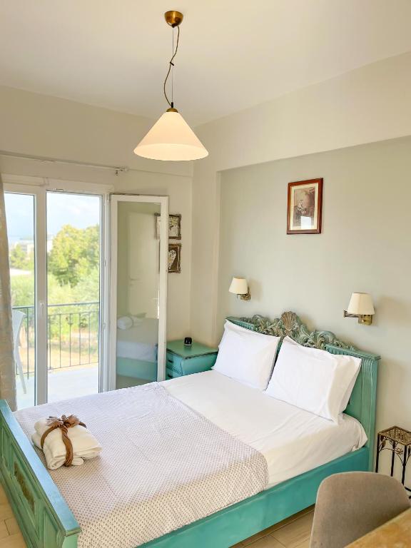 a bedroom with a bed and a balcony at Braziliana Apartments Corfu in Dassia
