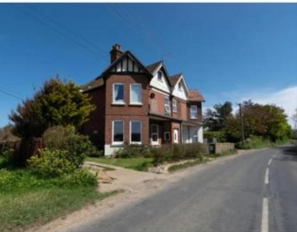 a large house on the side of a road at Ocean Retreat Norfolk in Trimingham