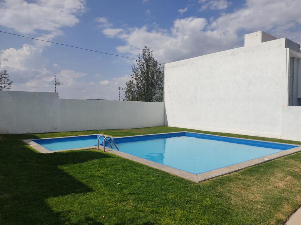 een zwembad in de tuin van een huis bij Comodidad y Tranquilidad a tu Alcance in San Juan del Río