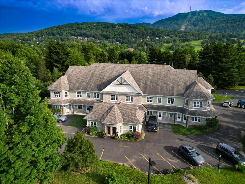 an aerial view of a large house with a parking lot at Le 201 Champlain Bromont in Bromont