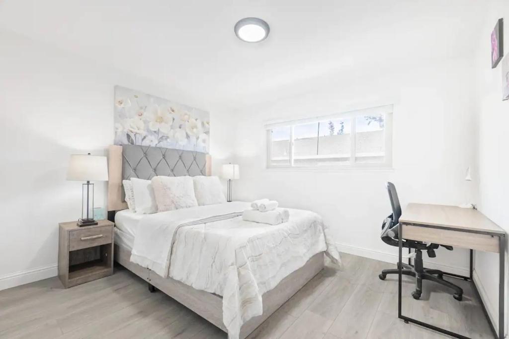 a white bedroom with a bed and a desk at 2BR APT with AC, Washer, Dryer, EV Connector, Parking in Cupertino in Sunnyvale