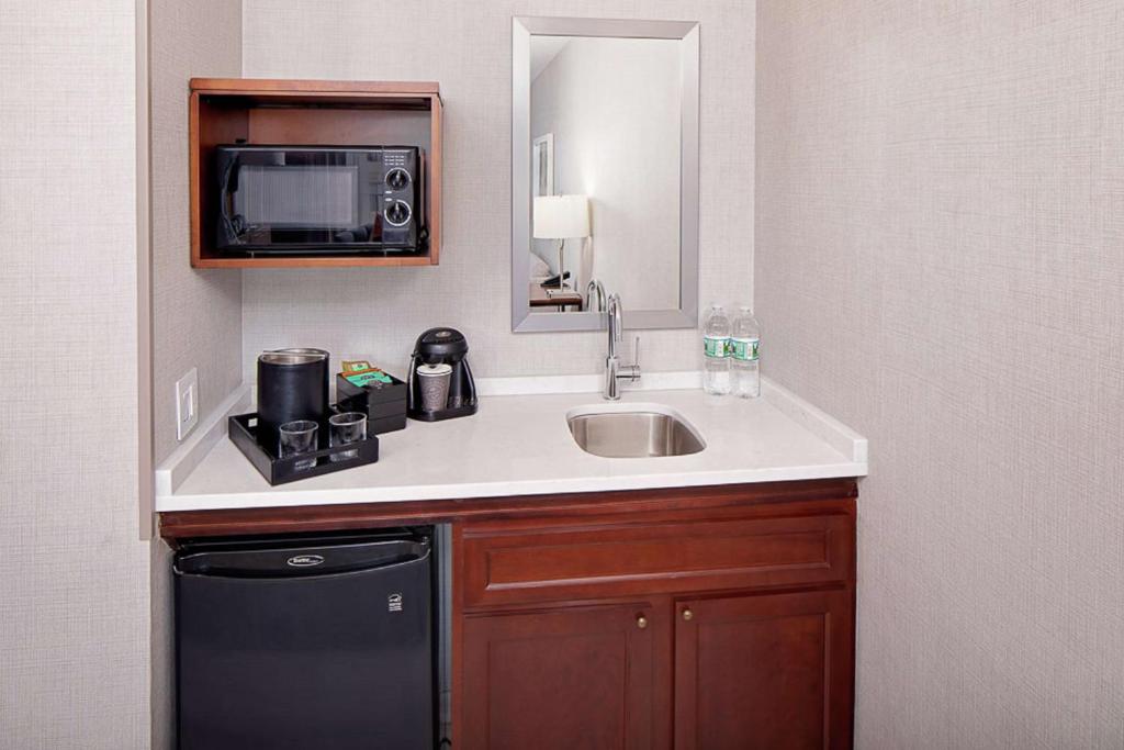 a bathroom with a sink and a microwave at Embassy Suites by Hilton Boston Marlborough in Marlborough