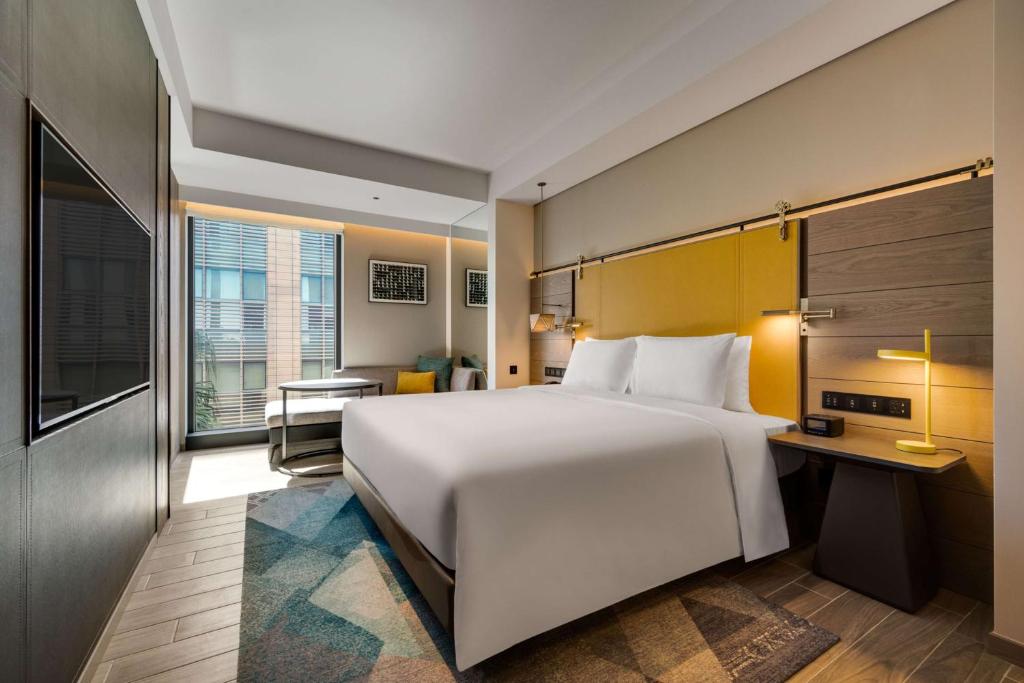 A bed or beds in a room at Hotel Resonance Taipei, Tapestry Collection by Hilton