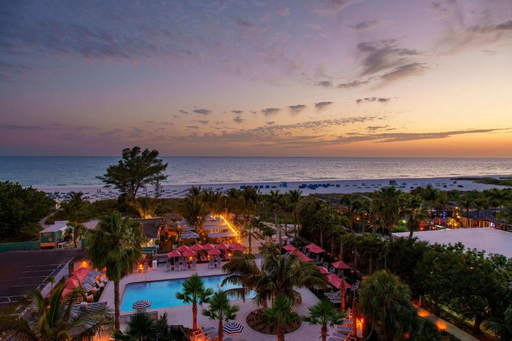 an aerial view of a resort with a pool and the ocean at Hilton Garden Inn St. Pete Beach, FL in St. Pete Beach