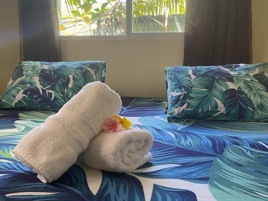 a stuffed animal is sitting on a bed at Toa Lodge Bora Bora in Bora Bora