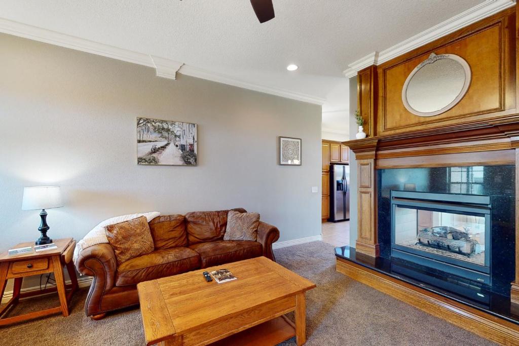 a living room with a couch and a fireplace at Windsor Retreat in Bentonville
