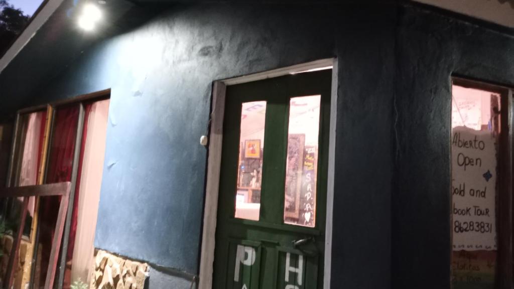 una puerta a un edificio con una puerta verde en Hostel Paco House, en Monteverde