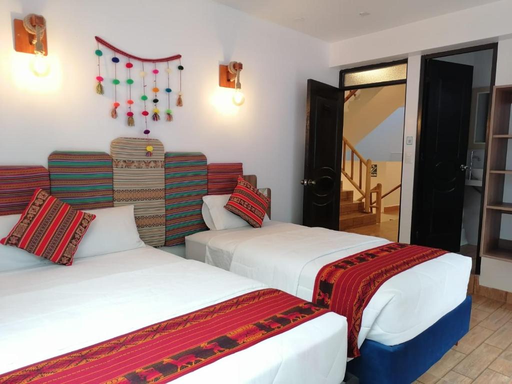 a hotel room with two beds and a staircase at Collection Machupicchu in Machu Picchu
