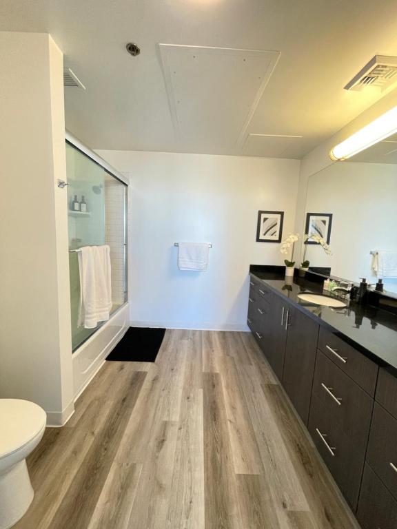 a bathroom with a sink and a toilet in a room at High Rise Studio in Heart of Ktown DTLA in Los Angeles